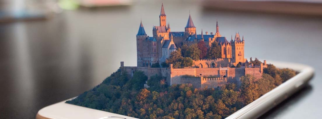 Teléfono móvil con un castillo en relieve saliendo de su pantalla